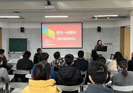 A person giving a presentation to a group of people  Description automatically generated with medium confidence